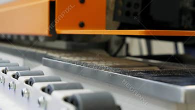 Close up of moving parts of the conveyor machine belt in the modern plant.