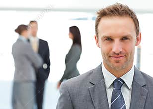 Proud manager posing in front of his team