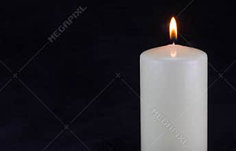 Burning candle in the dark with copy space