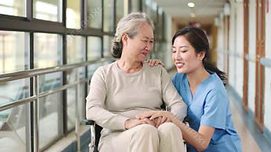 Friendly staff talking to senior woman in nursing home