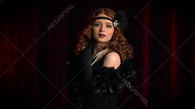 Old-fashioned sexy woman dressed in style of Flappers posing on dark background. Roaring twenties, retro, party, fashion
