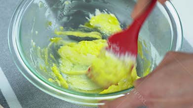Mixing egg yolk with butter