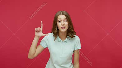 You lost	 your fault! Young brunette woman in polo t-shirt making loser gesture