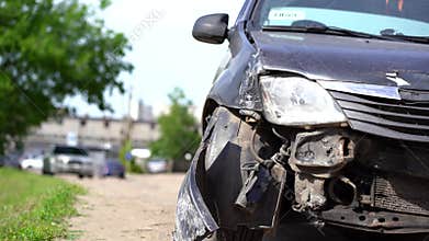 The car after the accident. Broken car on the road. The body of the car is damaged as a result of an accident. High speed head on