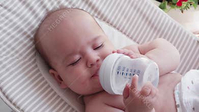 Infancy, childhood, summer holiday, medicine and health concept - Close-up top view portrait of awake newborn baby girl