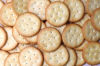 Biscuits are stacked on the wooden table with selective focus.