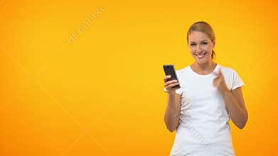 Happy young woman pointing at smartphone hand, easy credit, online application