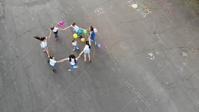 CHERKASY, UKRAINE, OCTOBER 5, 2019: Aero, top view. round dance. children spin, twist, dance merrily, with balloons. in