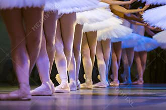 Legs of ballerinas dancing in ballet