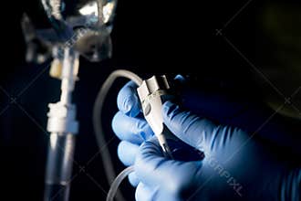 Nurse adjusts IV Drip Flow Rate