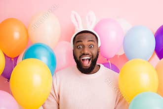Photo of funny dark skin guy colorful decorations easter party festive mood open mouth wear sweater fluffy bunny ears on