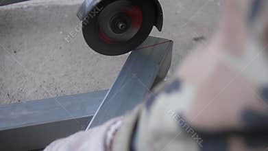 The hand of man using Electric grinder cutting the galvanized steel