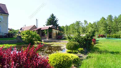 private house and beautiful yard. picturesque day with clear blue skies. House in a rural area with majestic nature