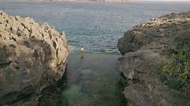 4K video of tourist standing at Angel's Billabong. Nusa penida, Bali, indonesia.