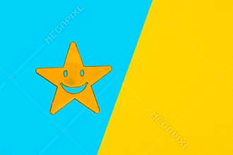 yellow star on blue part of blue-yellow background, creative art design, copy space, abstract idea