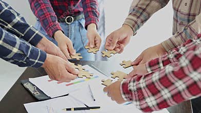 Business team is connecting puzzle pieces, unity, cooperation, teamwork