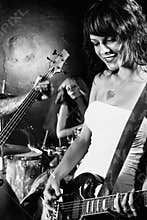 Female guitarist playing in her band