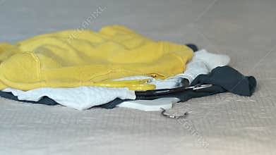 Women's clothes fall on the bed, the concept of decluttering, sorting out a woman's wardrobe or cleaning before