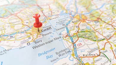 A red pin stuck in Cardiff on a map of Wales