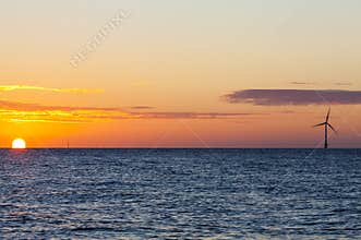 Offshore wind turbine at sunrise