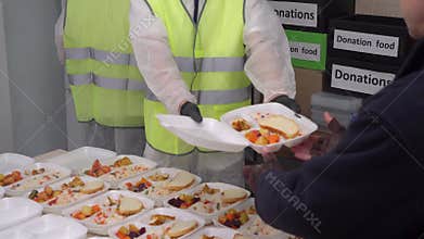 Refugee Camp. Humanitarian organizations and volunteers helping Ukrainian refugees. Distribution of hot food