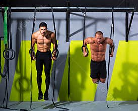 Crossfit dip ring two men workout at gym