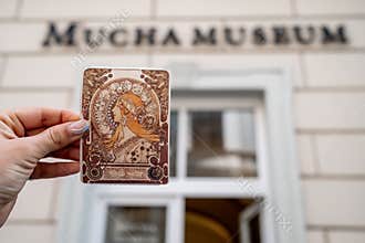 Prague, Czech Republic - July 2022. Alphonse Mucha Museum. Woman holding ticket with Zodiac calendar for La Plume