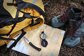 Hiking shoes on map with compass
