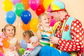 Happy children and clown on birthday party