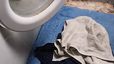 Dirty things fall to the floor near the washing machine