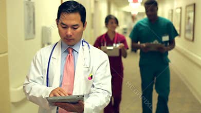 Medical Staff Working At Busy Nurses Station