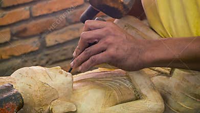 Cambodia, Siem Reap. Carving Buddha statue from a wood