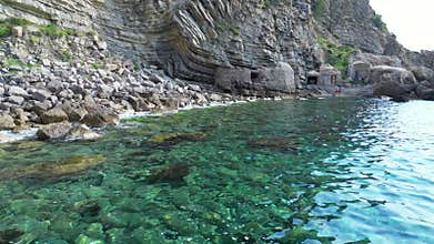 Crystalline water bathes rocky coast of Ibiza. Gorgeous aerial view flight drone