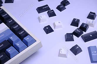 Scattered PBT Doubleshot Keycaps on a Clean White Desk, Coloured White, Blue, and Black