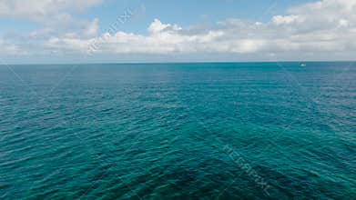 Expansive view of clear turquoise ocean under blue skies. Boracay Island, Philippines.