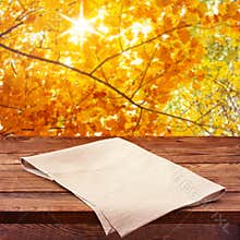 Empty wooden deck table with tablecloth