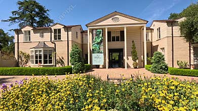 footage of the Boddy House museum with colorful flowers and lush green trees and plants at Descanso Gardens La Canada Flintridge
