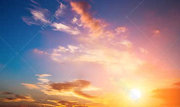 Sunset sky and sun. Dramatic sunset sky with orange colored clouds and sun.