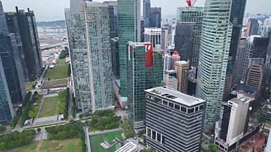 Real time aerial video of Singapore City Skyline. Flying Towards Marina Bay Sands and Gardens In Singapore