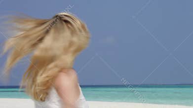 Woman With Arms Outstretched On Beautiful Beach