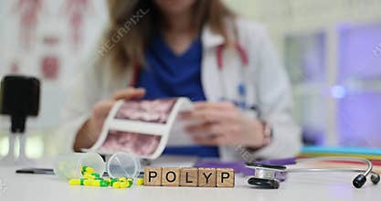 Word Polyp and capsules against doctor examining patient scans