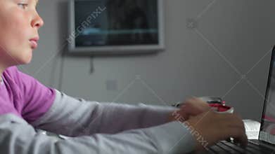 Boy Studying In Bedroom Using Laptop