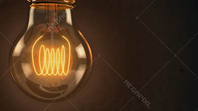Close up of an illuminated vintage hanging light bulb over dark