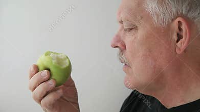 Man eats green apple