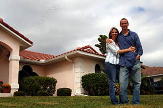 Couple in front of home