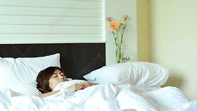 Asian woman teenager wake up and relaxation in bed