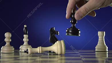 Man playing chess, and shows the hand of chess pieces