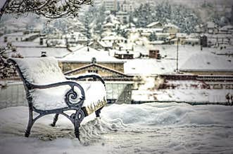 Snow covered empty bench