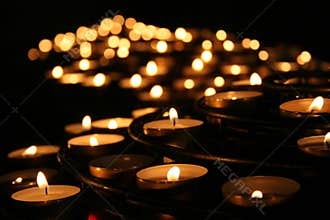 Charity. Praying candles in a temple.