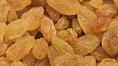 Golden Raisins Close Up, Dried Grapes Texture Healthy Food Background.